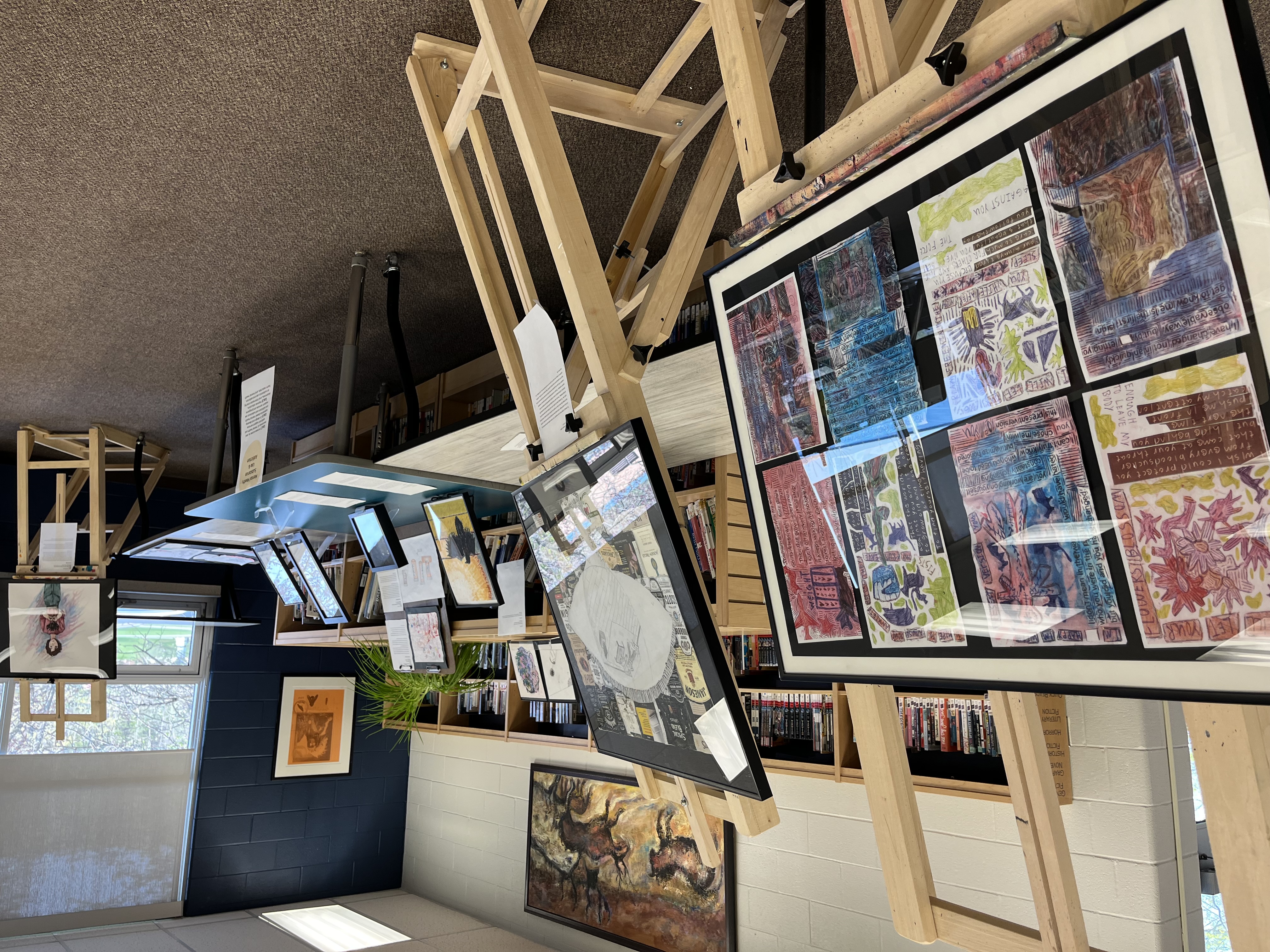 A view of the CSWB Youth Art Exhibition held at HHSS on May 10. Artwork arranged on easels can be seen in foreground and background.