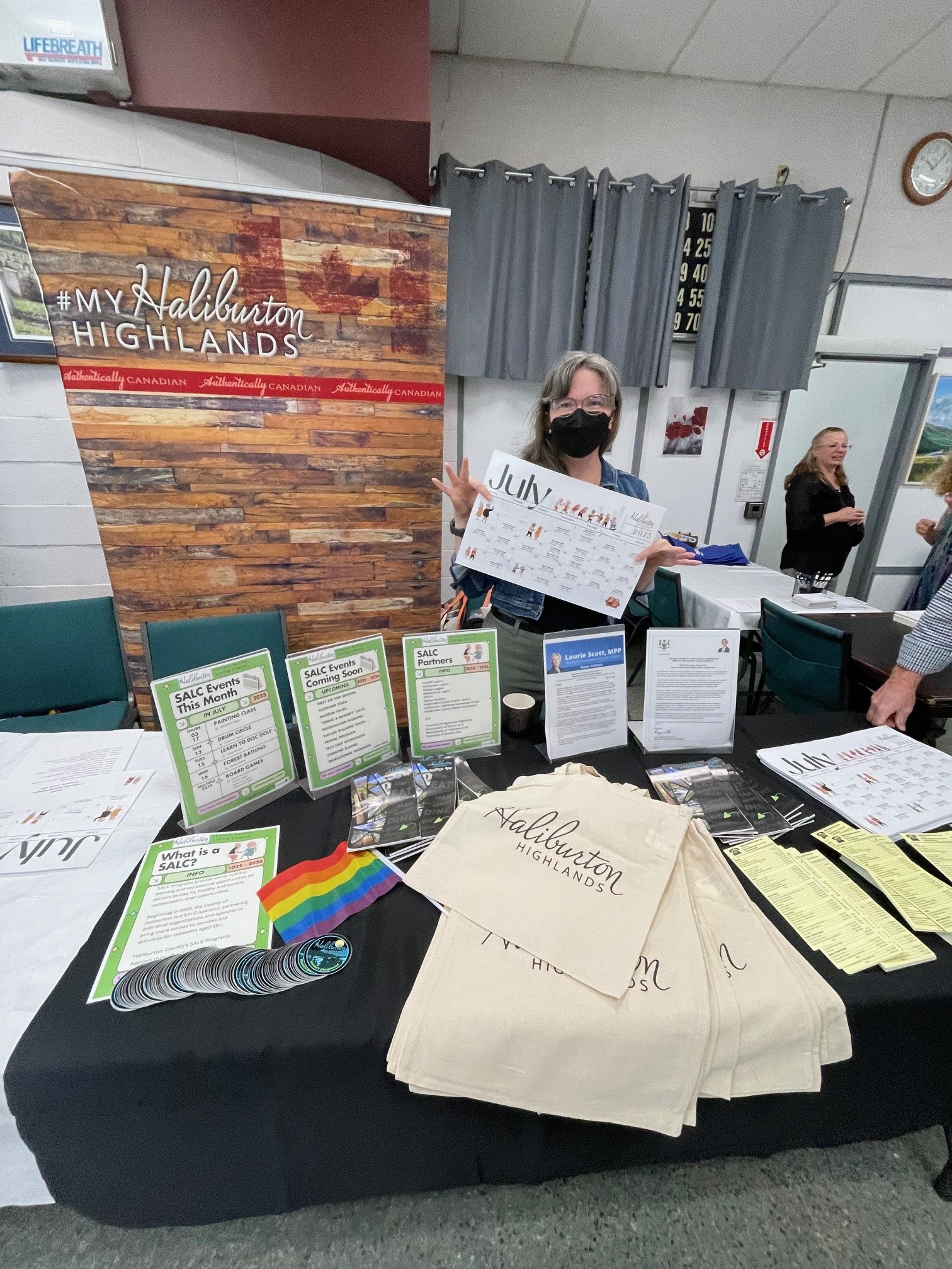 Director of Community Outreach Sue Tiffin holds the July calendar at the launch of the 2025 Seniors Active Living Centre program.
