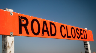 Orange sign that reads Road Closure