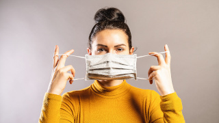 Woman putting on a mask