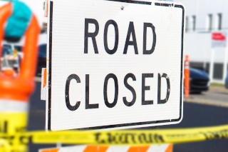 White sign that says Road Closure