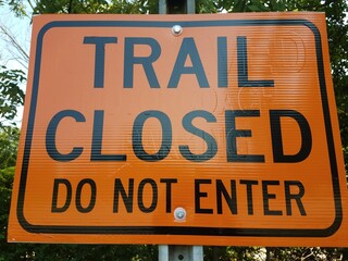 Orange sign that reads Trail Closed