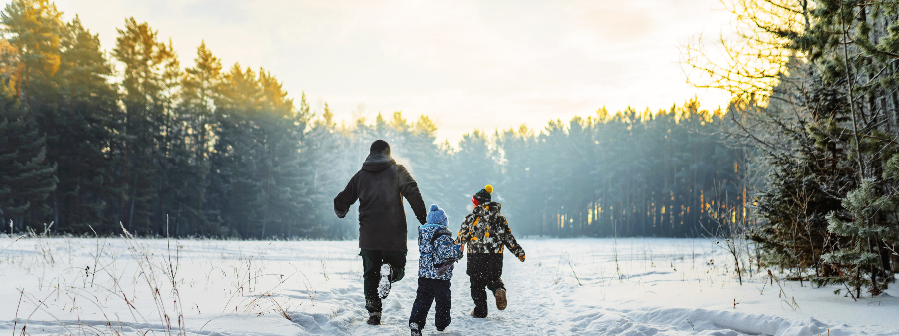 Dad and kids running in the snow
