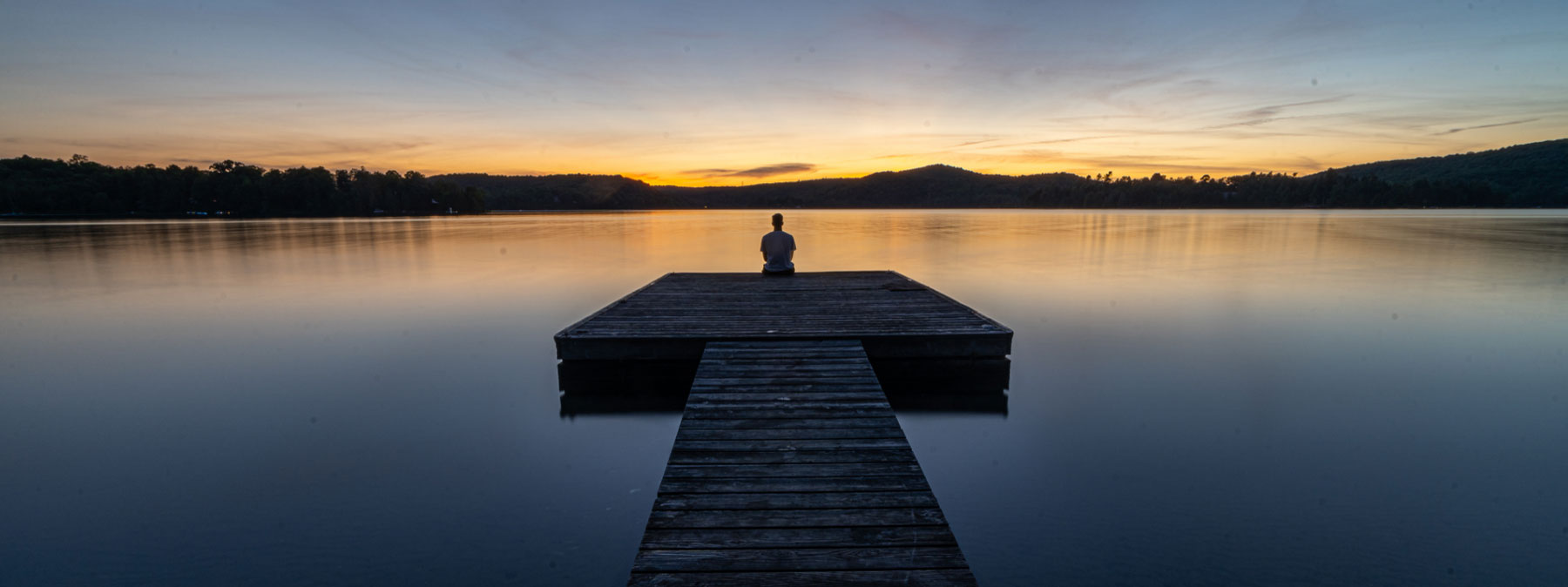 person sitting on a dock