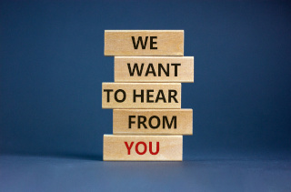 wooden blocks with the words "we want to hear from you" written on them.